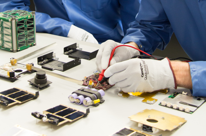 UK students Timothy Lim and Zachary Porter working in the UK Space Systems Lab on what would become SGSat. Photo by Jacob Owen