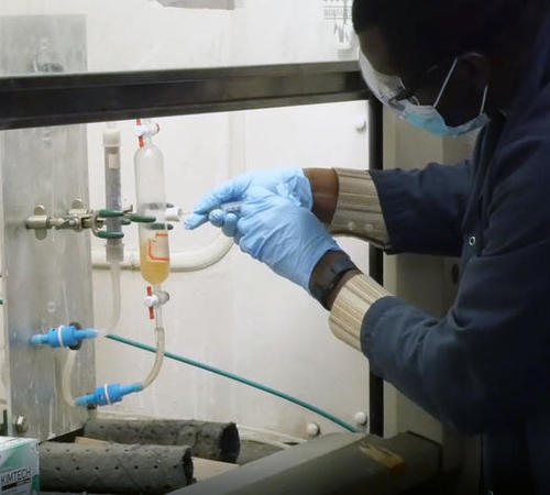 Reynolds Frimpong, senior research engineer at CAER, works on a carbon dioxide capture experiment.